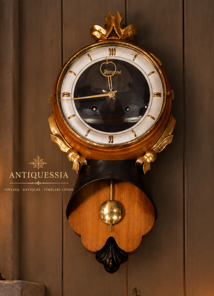 Vintage Swedish Westerstrand mechanical pendulum wall clock dating to around 1945, featuring a polished wooden case, circular dial, brass-tone decorative details and visible pendulum.
