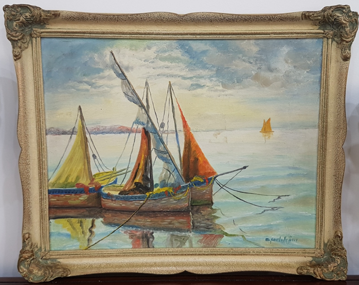 Original mid-century Scandinavian oil painting by Carl Julius, depicting colorful traditional fishing sailboats moored on calm waters at sunset, framed in a heavy ornate gold-toned wooden border.