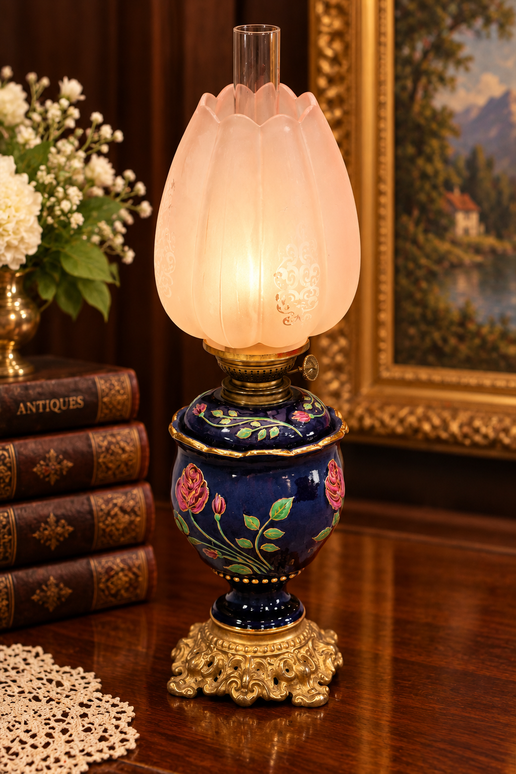 Antique porcelain oil lamp featuring a rich cobalt blue body with delicate floral decoration, elegant gilt detailing, and classic late 19th-century design.