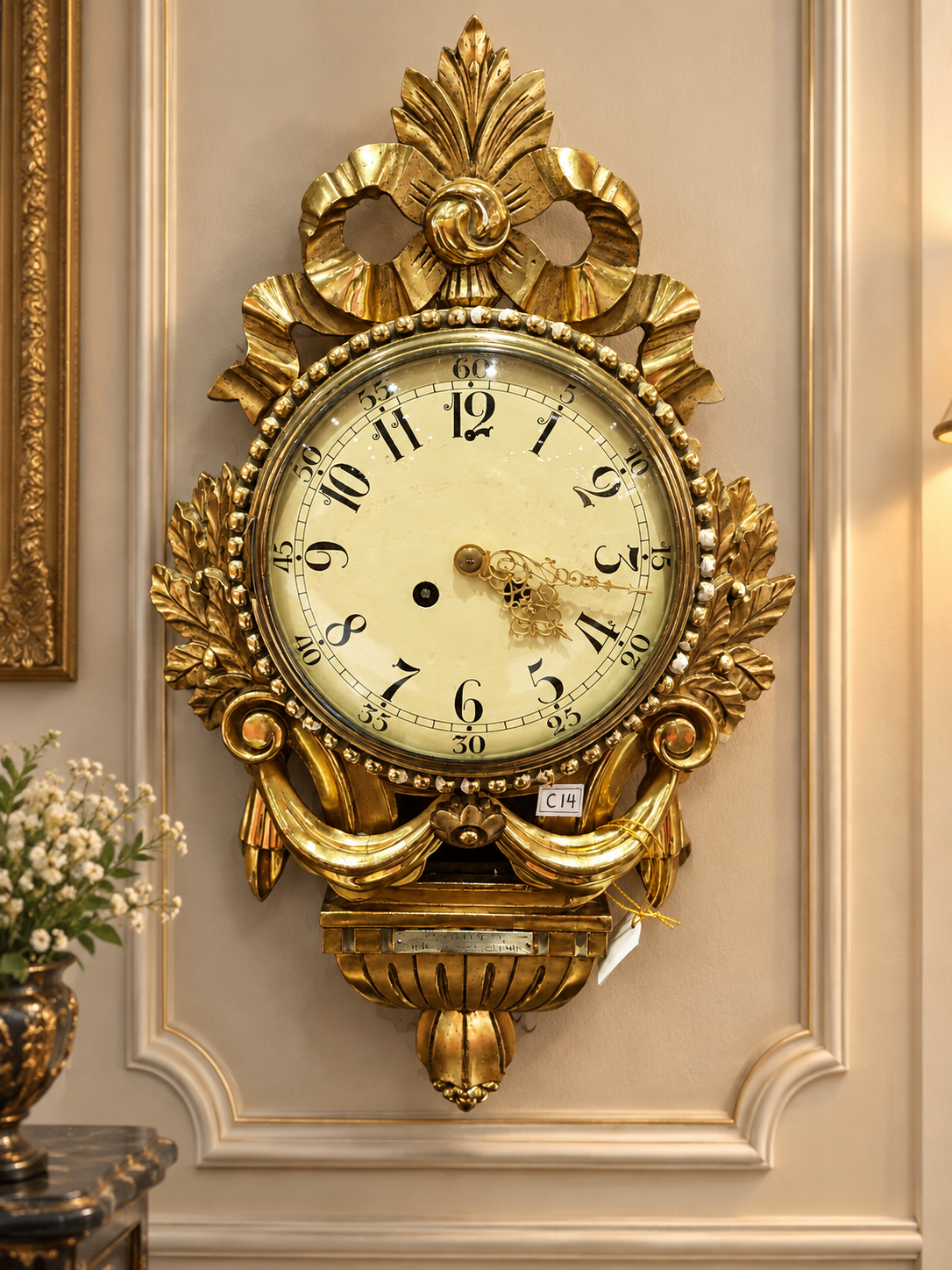 Antique Swedish giltwood cartel wall clock featuring an ornate sculptural frame, decorative gilded details, and classic early 20th-century Scandinavian design.