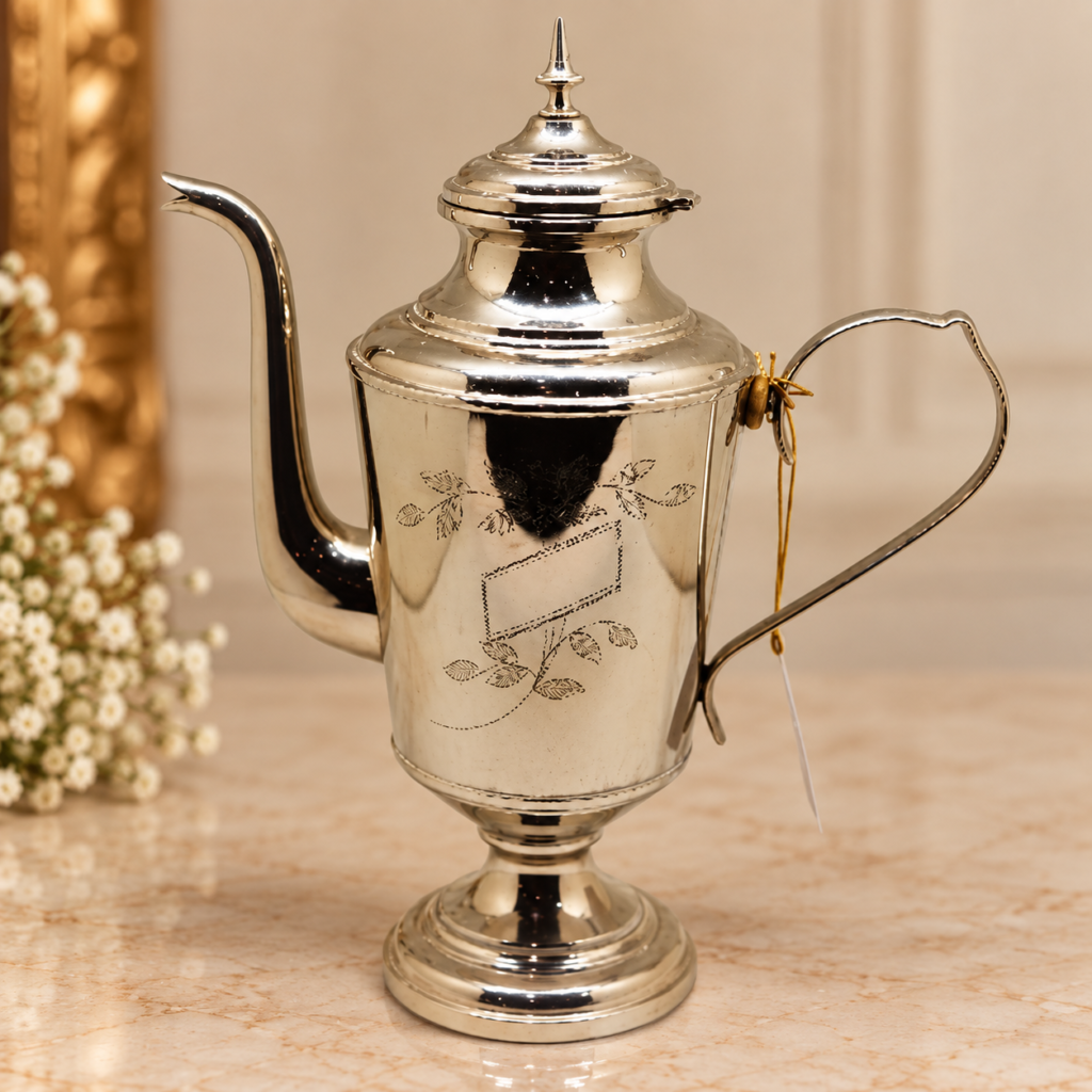 An elegant vintage Swedish silver-plated coffee pot featuring a hand-engraved floral cartouche, a slender looping handle, and a tiered pedestal base on a white background.