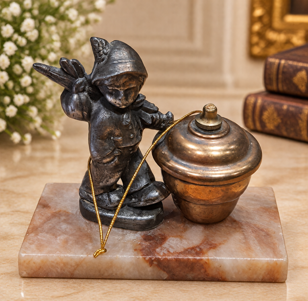 An antique 1920s Art Deco figural desk lighter featuring a patinated metal wandering boy sculpture next to a brass lighter urn, mounted on a polished marble base.