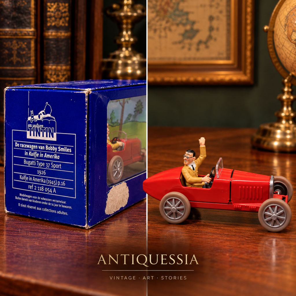 Vintage En Voiture Tintin die-cast red 1926 Bugatti Type 37 Sport model car featuring the Bobby Smiles figurine inside its original blue and clear showcase box.