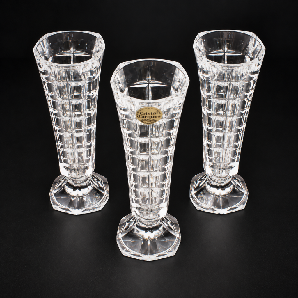Set of three vintage French Cristal d'Arques bud vases crafted from 24% genuine lead crystal, featuring an Art Deco geometric block basketweave pattern with a flared rim and a sturdy pedestal-footed base.