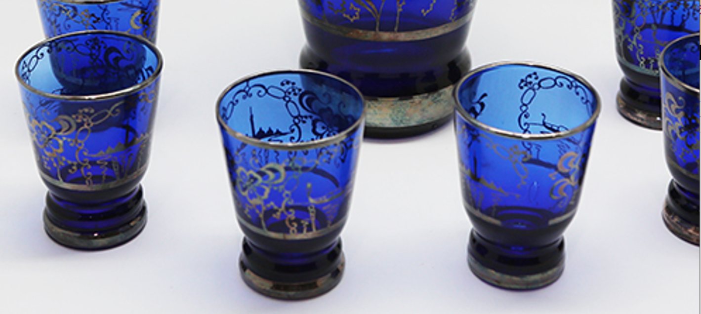 Seven-piece vintage Italian Murano cobalt blue glass liquor decanter set with matching stopper and six shot glasses adorned with detailed sterling silver floral overlay filigree.