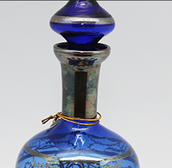 Seven-piece vintage Italian Murano cobalt blue glass liquor decanter set with matching stopper and six shot glasses adorned with detailed sterling silver floral overlay filigree.