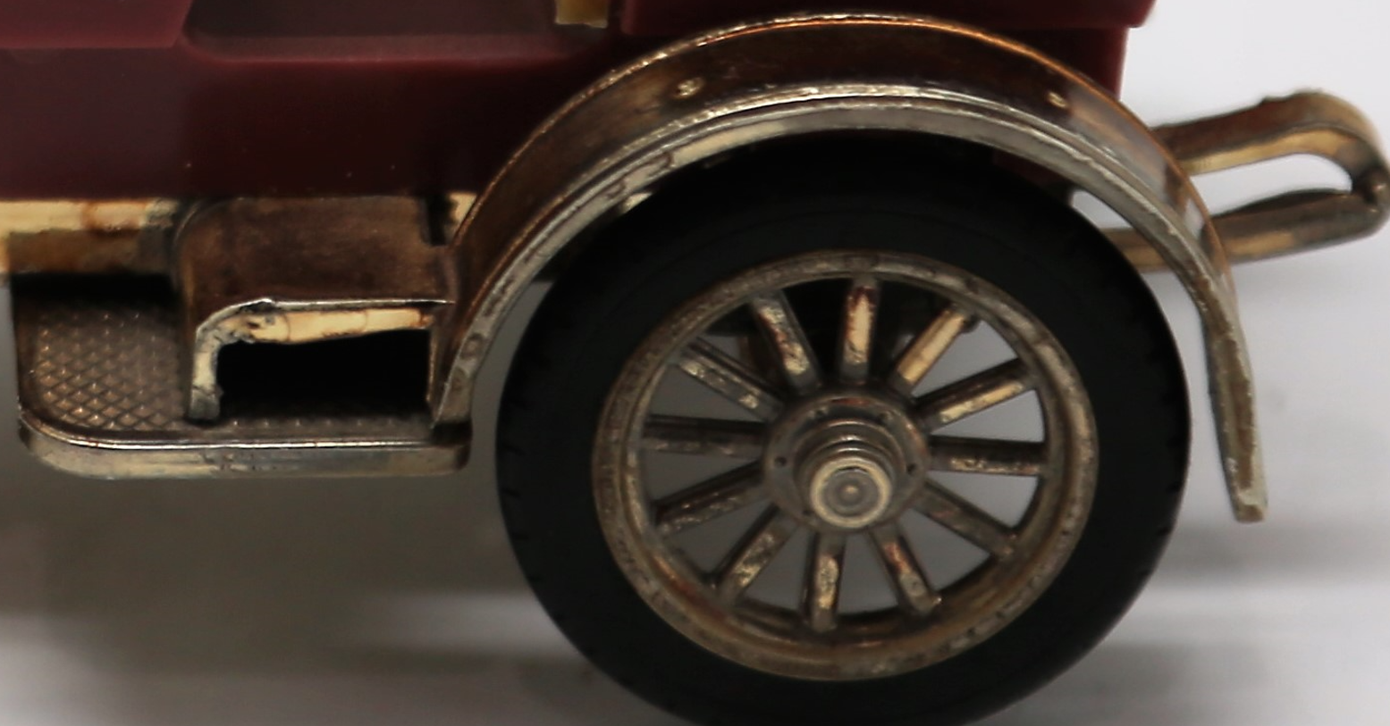 Vintage Gama Germany 1:43 scale diecast model of a 1902 Mercedes Simplex classic car, featuring a maroon body, tan seats, black folding canopy roof, and bright gold fenders and wheels.