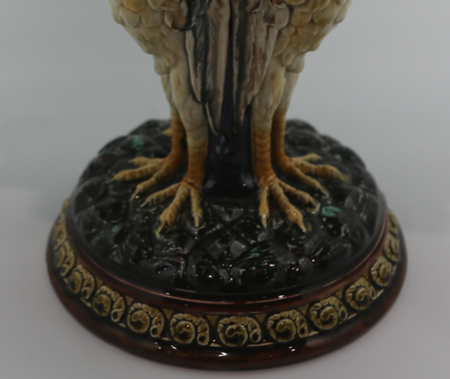 Antique Swedish Rörstrand majolica centerpiece bowl supported by a pedestal base shaped like three storks with a vibrant turquoise blue interior.