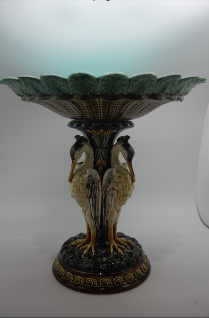 Antique Swedish Rörstrand majolica centerpiece bowl supported by a pedestal base shaped like three storks with a vibrant turquoise blue interior.