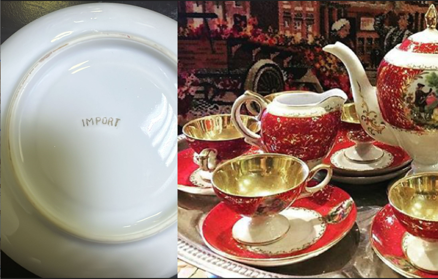 Extensive vintage European ruby red porcelain tea set with a large teapot, creamer, sugar bowl, and pedestal teacups featuring fully gold-gilded interiors and romantic Courting Couple scenes.