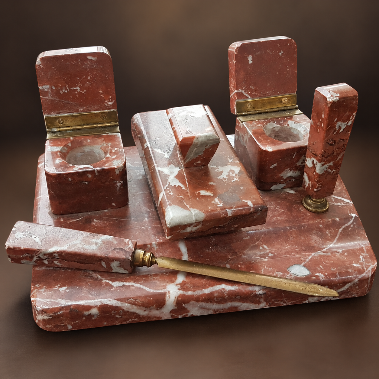 Antique 1930s Art Deco Rosso Levanto red marble five-piece executive desk set with two brass-hinged inkwells, matching marble blotter and brass letter opener.