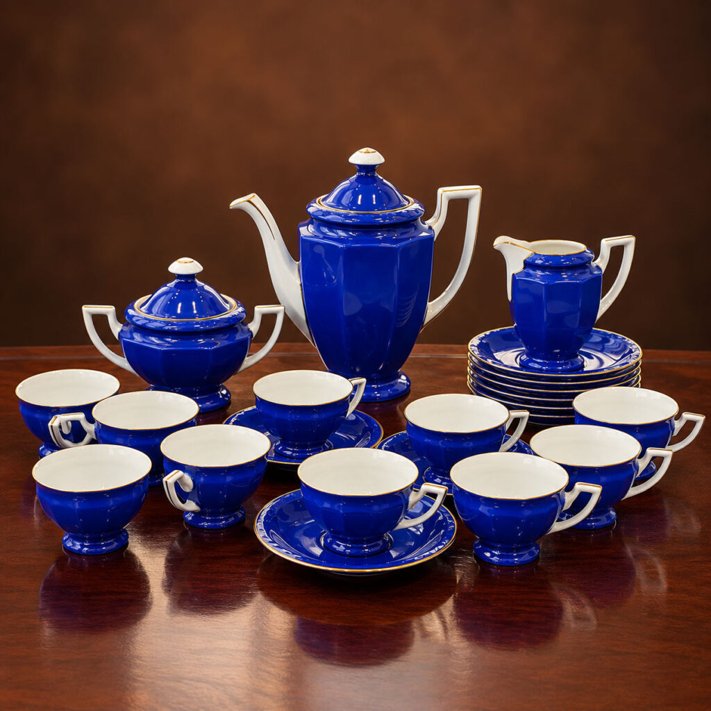 Vintage 1960s Czechoslovakian 25-piece cobalt blue porcelain tea and coffee set with geometric faceted shapes, white handles and delicate gold-gilt trim.
