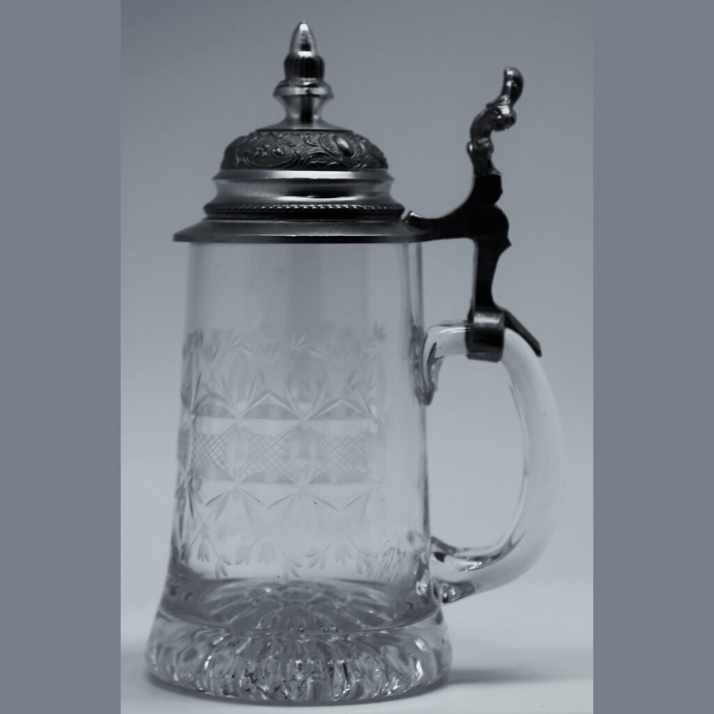 Vintage 1970s German cut crystal beer stein with diamond pattern, heavy glass base, clear handle, and ornate hinged dome pewter lid.