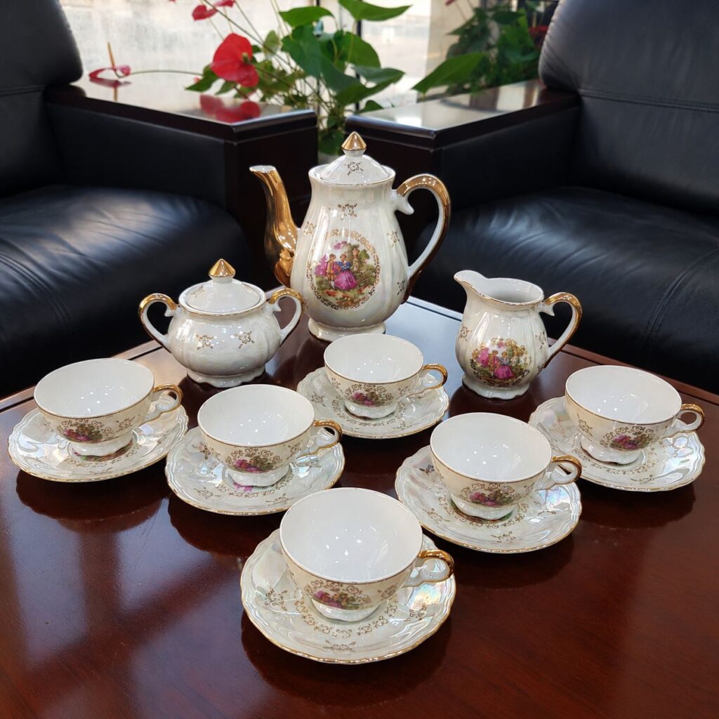 Vintage 15-piece Japanese porcelain tea set with romantic Fragonard-style courting couple scenes, pearlescent white finish, gold handles, teapot, sugar bowl, milk jug, cups and saucers.