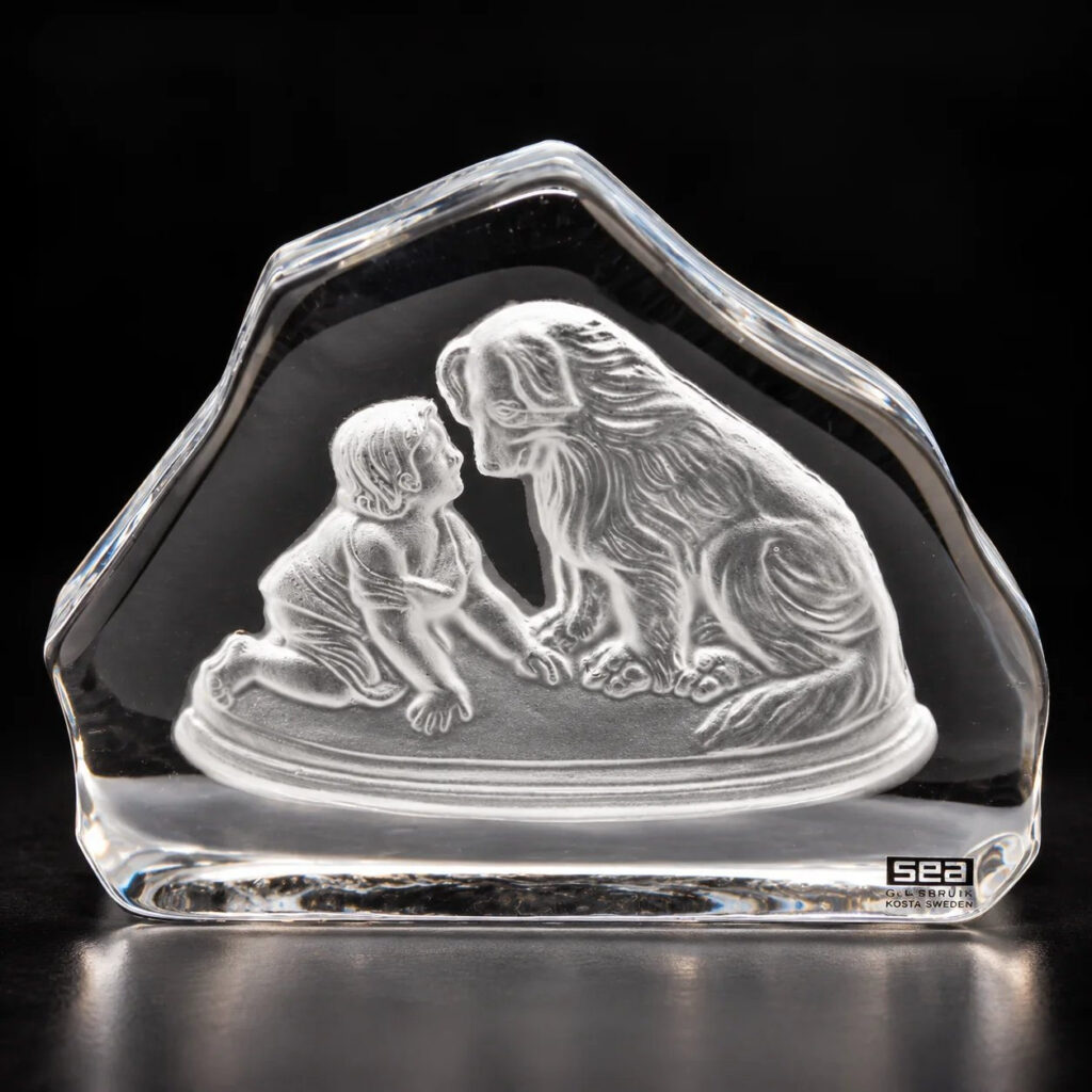 Vintage 1970s SEA Glasbruk Kosta Sweden clear crystal paperweight featuring a frosted relief sculpture of a young child and a large dog.